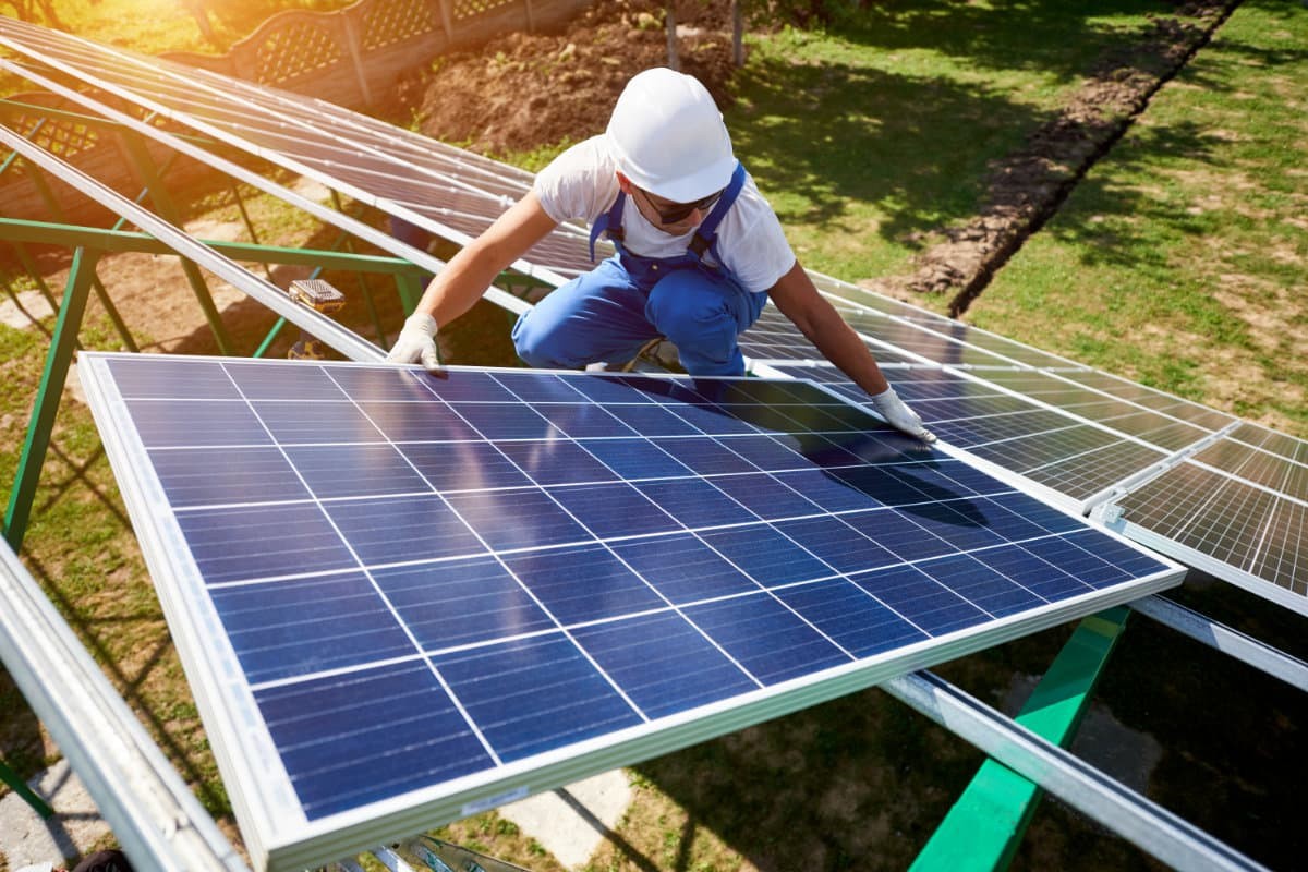 Man installing solar panel.
