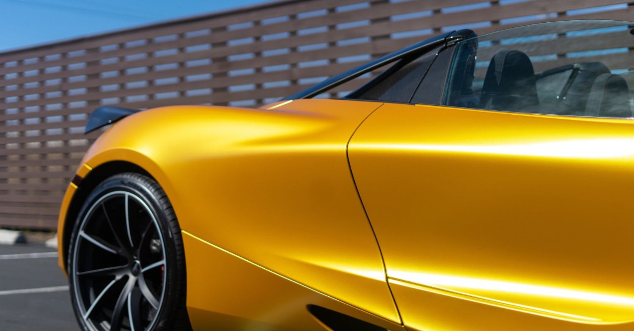 Sports car with stylish yellow vinyl wrap.