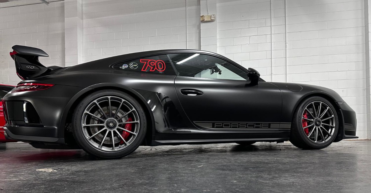 Sports car with stylish black vinyl wrap.